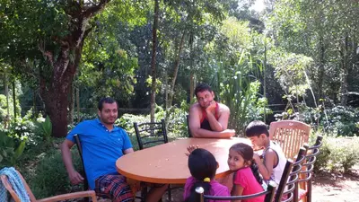a group of people sitting around a table at Marsim Holiday Resort in Vythiri