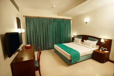 a hotel room with a bed and a television at Hotel Elite Palazzo in Kāladi