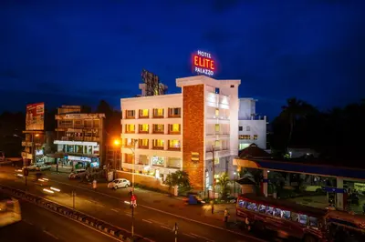 a building with a neon sign on top of it at Hotel Elite Palazzo in Kāladi