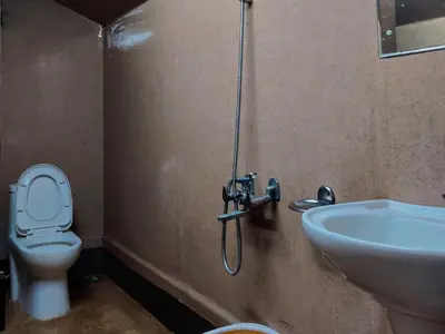 a bathroom with a toilet and a sink at ExoticaHolidays in Sultan Bathery