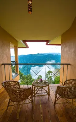 a balcony with a table and chairs and a view at After the Rains - Rainforest Lodge in Meppādi
