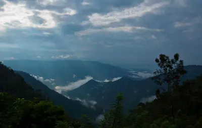 a view of a mountain valley with clouds in the sky at After the Rains - Rainforest Lodge in Meppādi