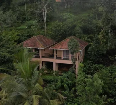 a house in the middle of a forest at After the Rains - Rainforest Lodge in Meppādi