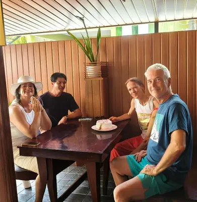 a group of people sitting at a table at Lakefront Beach Homes in Cherai Beach