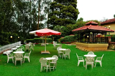 a group of tables and chairs and a gazebo at Fortune Resort Sullivan Court, Ooty - Member ITC Hotels' Group in Ooty