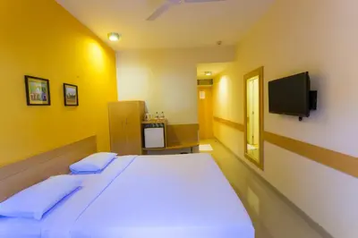 a hospital room with a bed and a tv at Ginger Mysore in Mysore