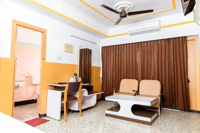 a room with a desk and chairs in a room at Hotel Srilakshmi in Coimbatore