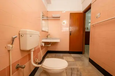 a bathroom with a toilet and a sink at Hotel Srilakshmi in Coimbatore