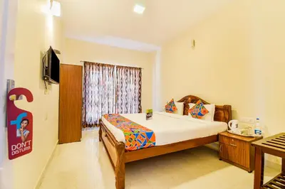 a bedroom with a bed and a television in it at FabHotel Vinu Valley Resorts - Nr Ketti Valley View Point in Ooty