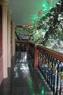 a hallway with a staircase with christmas lights at ShivalayaHomestay in Trichūr
