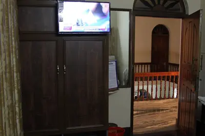 a flat screen tv on top of a cabinet at ShivalayaHomestay in Trichūr