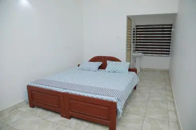 a bedroom with a bed in a room at Thekkumpuram Tourist Home in Malappuram