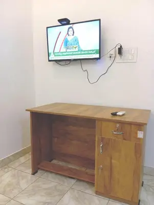 a flat screen tv hanging on a wall at Thekkumpuram Tourist Home in Malappuram