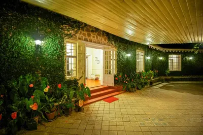 a room with plants and a door with a bunch of flowers at Talayar Valley Bungalow in Idukki