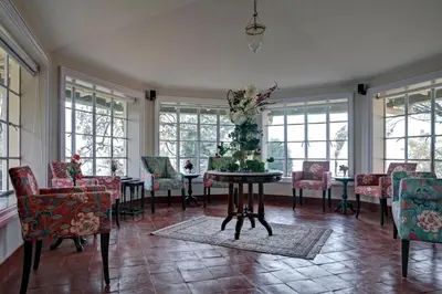 a room with a table with a christmas tree on it at Talayar Valley Bungalow in Idukki