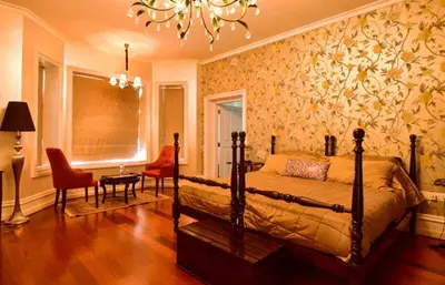a bedroom with a bed and a chandelier at Talayar Valley Bungalow in Idukki
