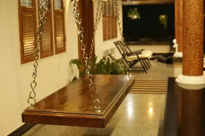 a swing in a living room with a porch at Mi Casa Tu Casa Homestay in Cochin