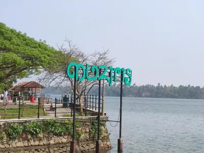 a sign on the side of a body of water at Takashi Homestay North Paravur Near Muziris in North Paravur