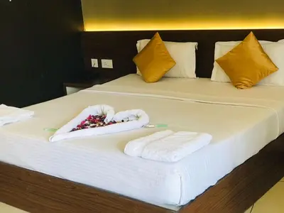 a hotel room with two towels on a bed at Wayanad Royal Crown in Kalpetta
