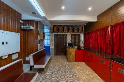 a kitchen with red cabinets and a red door at Sri Nandha Luxury Comforts in Vālpārai
