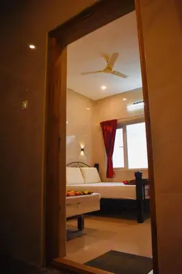 a view of a bedroom with a bed and a window at Sri Nandha Luxury Comforts in Vālpārai