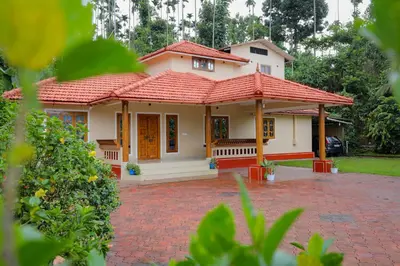 a small house with a red roof at Nandanam Villa in Kaniyāmbetta