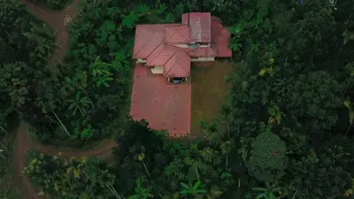 an aerial view of a house in the middle of a forest at Nandanam Villa in Kaniyāmbetta
