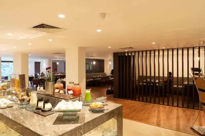 a large living room with a lobby with a table at Southern Star,Mysore in Mysore