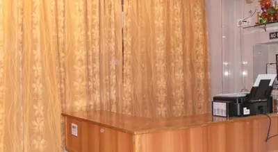 a desk with a fax machine on top of a counter at vrs dormitary in Mysore