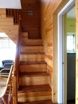 a staircase in a house with wooden walls at Relaxing 2 B/R Estate House, Deenaty, Tamil Nadu in Coimbatore