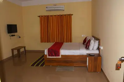 a bedroom with a bed and a television in a room at KSTDC Hotel Mayura Bharachukki, Shivanasamudra in Sivasamudram