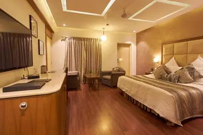 a hotel room with a bed and a sink at Sandesh The Prince in Mysore