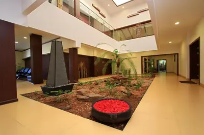 a hallway with plants in a building at Silent Shores Resort & Spa in Mysore