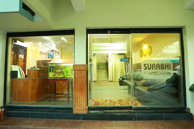 a window of a store with a sign in it at Surabhi Suites in Angamali