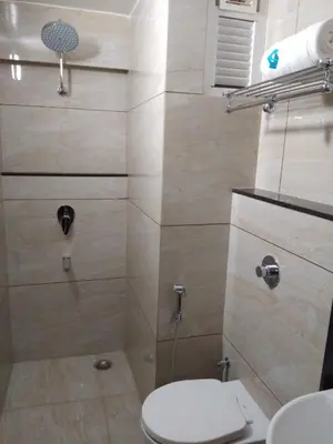 a bathroom with a shower with a toilet at Hotel iStay in Coimbatore