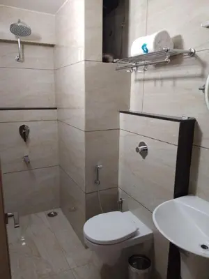 a bathroom with a toilet and a sink at Hotel iStay in Coimbatore