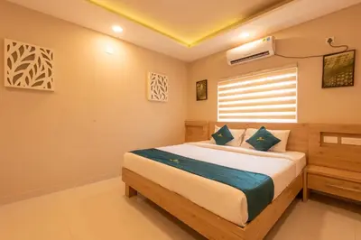 a bedroom with a large bed in a room at Daan Ambalath Maple Leaves in Guruvāyūr