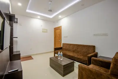 a living room with a couch and a coffee table at Daan Ambalath Maple Leaves in Guruvāyūr