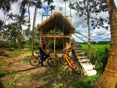 two men with their bikes in front of a gazebo at Paddyfield Inn in Mananthavady