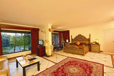 a large bedroom with a bed and a living room at Emarald Resort in Pulamanthole