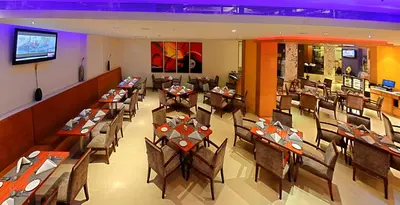 an overhead view of a restaurant with tables and chairs at Gokulam Park Coimbatore in Coimbatore