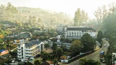 an aerial view of a city with buildings at Eastend Munnar in Munnar