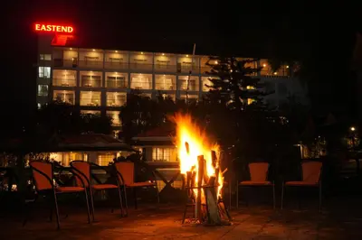 a fire pit in front of a hotel at night at Eastend Munnar in Munnar