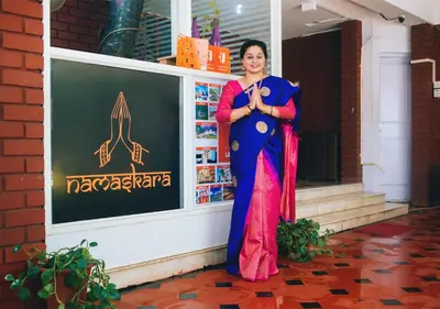 a woman standing in front of a building at Zostel Mysore in Mysore