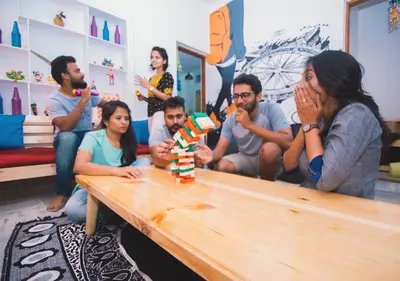 a group of people sitting around a table at Zostel Mysore in Mysore