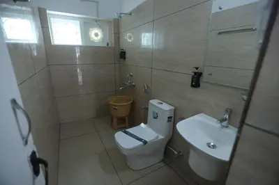 a bathroom with a toilet and a sink at Tiger Hill Homestay in Ooty