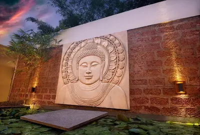 a wall with a picture of a statue on it at Amanvana Spa Resort, Coorg in Kushālnagar