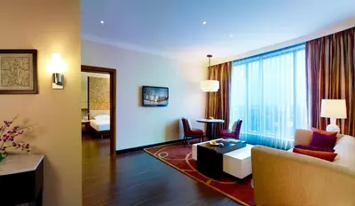 a living room with a couch and a table in a room at Vivanta Coimbatore in Coimbatore