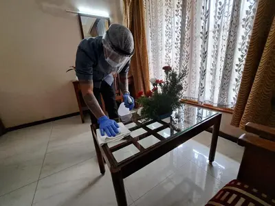 a man is working on a coffee table at Hotel Preethi Classic Towers in Ooty