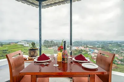 a wooden table with plates of food on top of a window at Sterling Ooty Elk Hill in Ooty